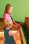 little girls sisters playing piano. Music lessons. Children try to play piano