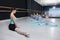 Little girls sit on the splis under the supervision of a teacher in a class of a choreographic school