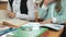 Little girls sitting at desk flips pages of book