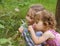 Little girls smelling flowers