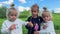 Little girls triplets with dandelions