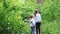 Little girls walking together in the woods. Rear view.