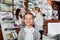 Little glad girl in the pharmacy with parents and pharmacist