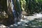 Little glorious waterfall among the rocks in mountain forest