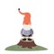 The little gnome stands on a tree stump