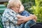 Little grandson hugs and kisses on the cheek of his beloved grandmother.The outdoors