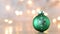 Little green Christmas ornament with glitter snowflake and blinking lights