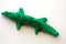 A little green crocodile made out of clay , isolated on the white background