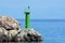 A little green lighthous o  the small cape on the island Rab in Adriatic sea