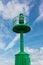 Little Green Metallic Lighthouse, Blue Sky and Clouds in Background