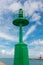 Little Green Metallic Lighthouse, Blue Sky and Clouds in Background