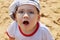 Little handsome boy in cap and glasses surprises