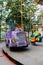 Little handsome boy rides in car of carousel in amusement park