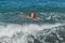 Little happy adorable girl child swims in the sea and plays on the waves during the holidays on the sea coast