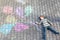 Little happy blond kid having fun with colorful air balloons picture drawing with colorful chalks. Creative leisure for