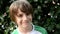 Little happy boy smiling on vegetation background