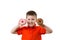 Little happy cute boy is eating donut on whte background wall. child is having fun with donut. Tasty food for kids