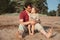 Little happy daughter and father laugh and lembrace one another on beach in summer