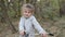 Little happy girl child rides a bicycle in the autumn forest