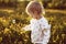 Little happy girl with a dandelion in hand