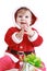 Little happy girl in red santa\'s clothes clapping