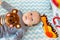 Little happy motivated child is playing with dangling rattles on background, toys for newborn, first toy