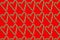 Little hearts from christmas candies on a red background. Seamless pattern wrapping paper concept, wallpaper, fabric pattern.