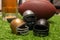 Little helmets  american football ball and beer on green grass