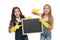 A little help for keeping things tidy. Adorable tidy schoolgirls in rubber gloves pointing at tidy blackboard. Primary