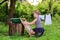 Little helper girlwashes clothes using the washboard outdoors