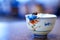 Little high school in uniform hang on to rim of tea cup