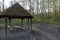 Little hiking hut in the middle of the forest with fresh green leaves in the spring. Little hut for a lunchbreak on a hike through