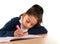 Little hispanic female child writing and doing homework with pink marker