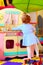 little hostess, girl at toy kitchen in kindergarten