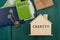 Little house with text & x22;Charity& x22;, keys, calculator, passport, gift box, money