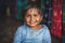 A little Indian girl looks at the camera and smiles at the photographer