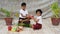 little Indian Sister tying Rakhi to Her little brother\'s wrist and exchanging gifts and sweets on Raksha Bandhan