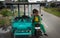 A little Indonesian boy rides a tuk-tuk and laughs merrily