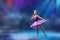 A little Japanese ballerina dances on stage in a lilac tutu on pointe shoes classical ballet