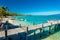 Little jetty and boat on tropical beach with amazing water, Moor