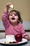 Little Jewish girl dipping apple slices into honey