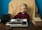 Little journalist work with vintage typewriter and camera at desk. Because I am a journalist