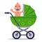 a little joyful child is sitting in a green baby carriage.