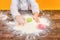 Little joyful girl in flour with Easter eggs