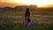 Little joyful sisters have fun outdoors play guitar dancing and jumping on the outdoors. dandelions field at sunset, Evening time,