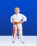 Little karateka with orange belt on a blue background