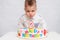 Little kid blows a candle on the cake on his birthday