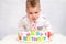 Little kid blows a candle on the cake on his birthday