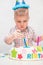 Little kid blows a candle on the cake on his birthday