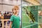 Little kid boy admire big turtles in terrarium through the glass